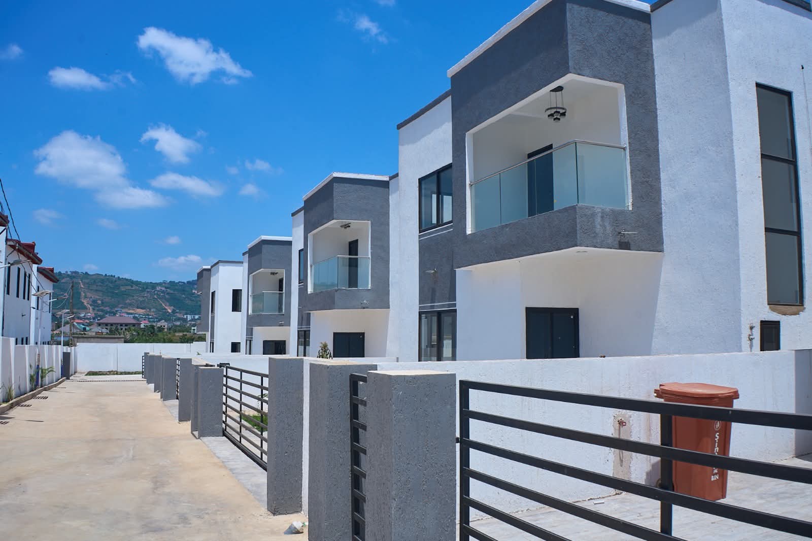 A row of finished homes with glass balconies
